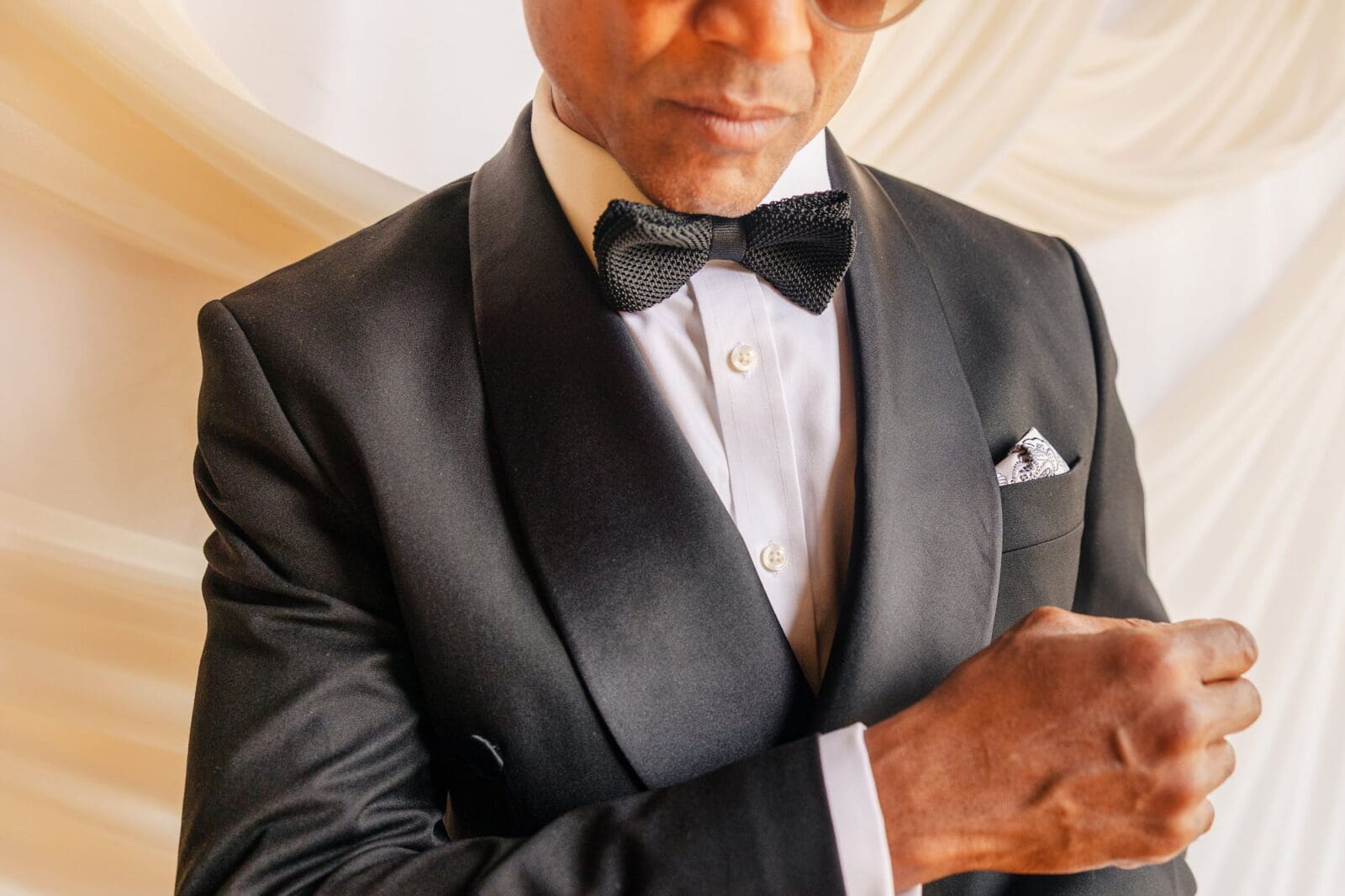 Groom in double-breasted satin lapel tuxedo by SUITD during Black Romance London editorial at Prince of Peckham
