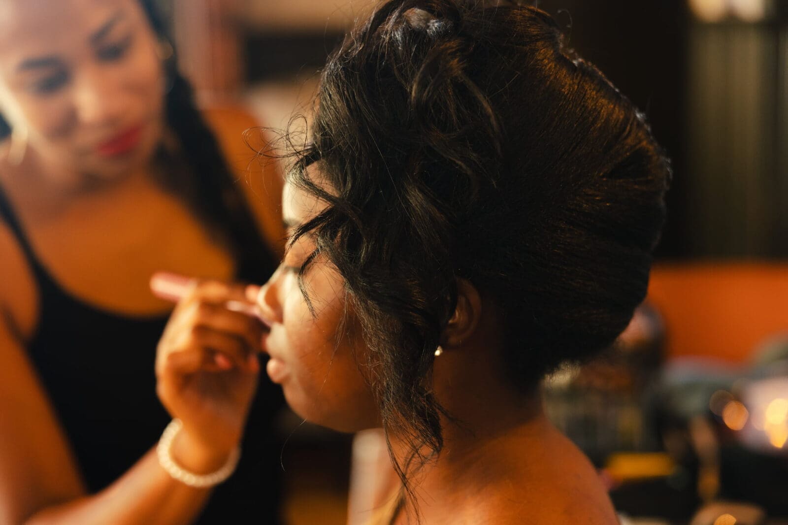 Bride having makeup applied by Brides by Aina during Black Romance London editorial at Prince of Peckham
