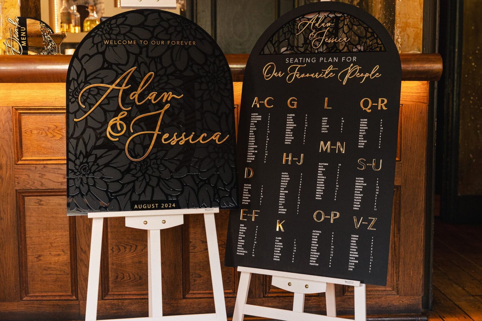 Black acrylic welcome sign and seating plan with gold typography by Recreate during Black Romance London editorial at Prince of Peckham"