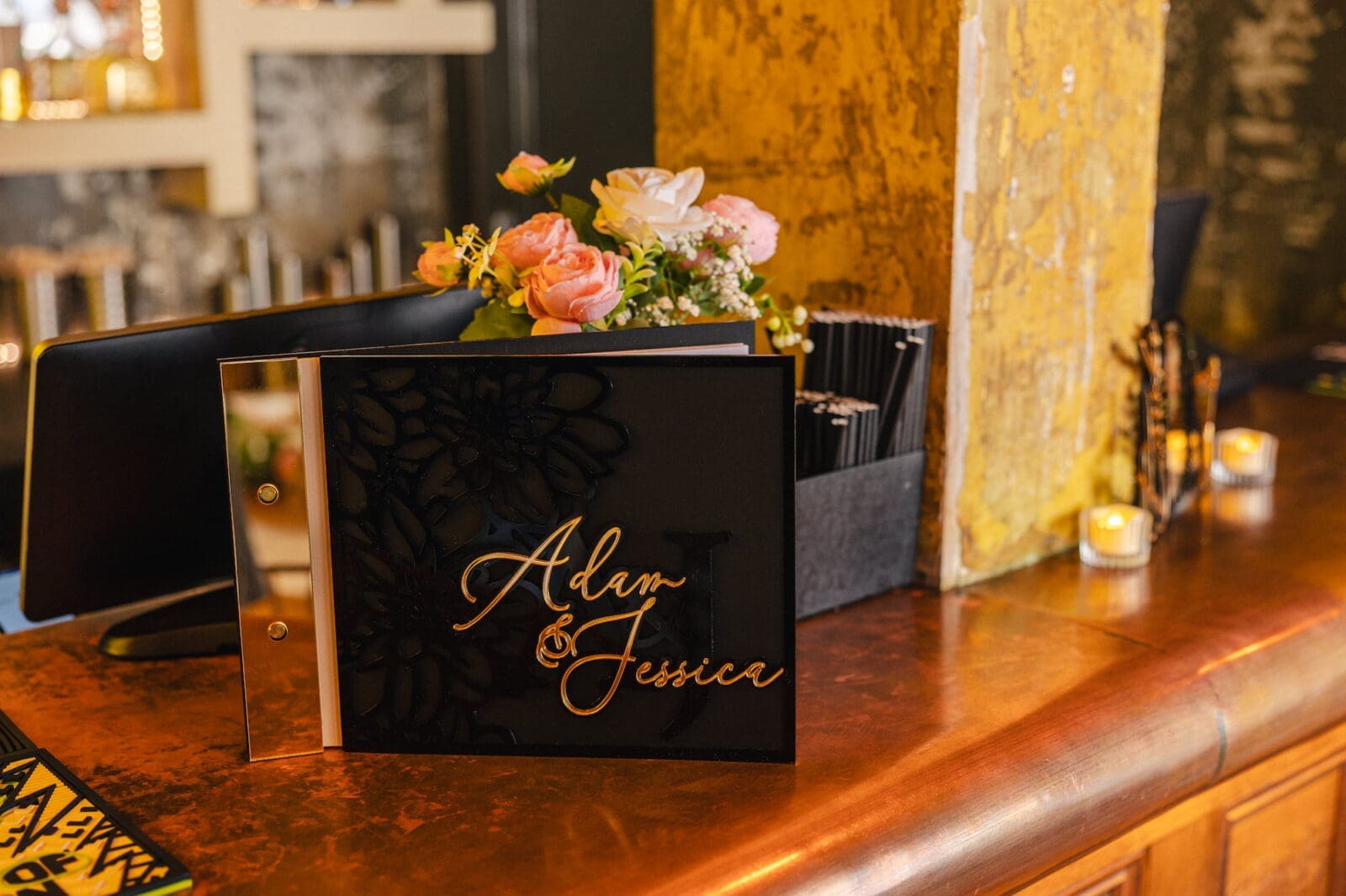 Black acrylic guest book with gold script typography by Recreate during Black Romance London editorial at Prince of Peckham