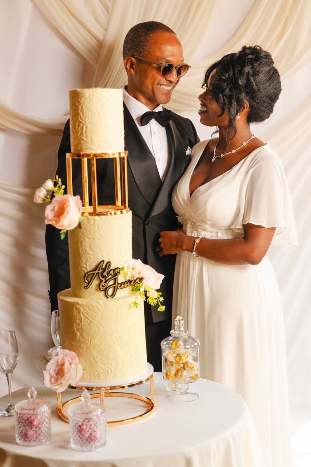 Black couple sharing a moment beside three tier wedding cake during Black Romance London editorial at Prince of Peckham