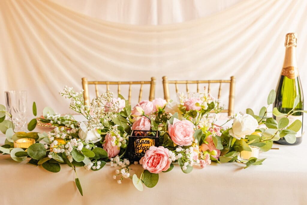 Blush and ivory floral table arrangement with eucalyptus and baby's breath during Black Romance London editorial at Prince of Peckham