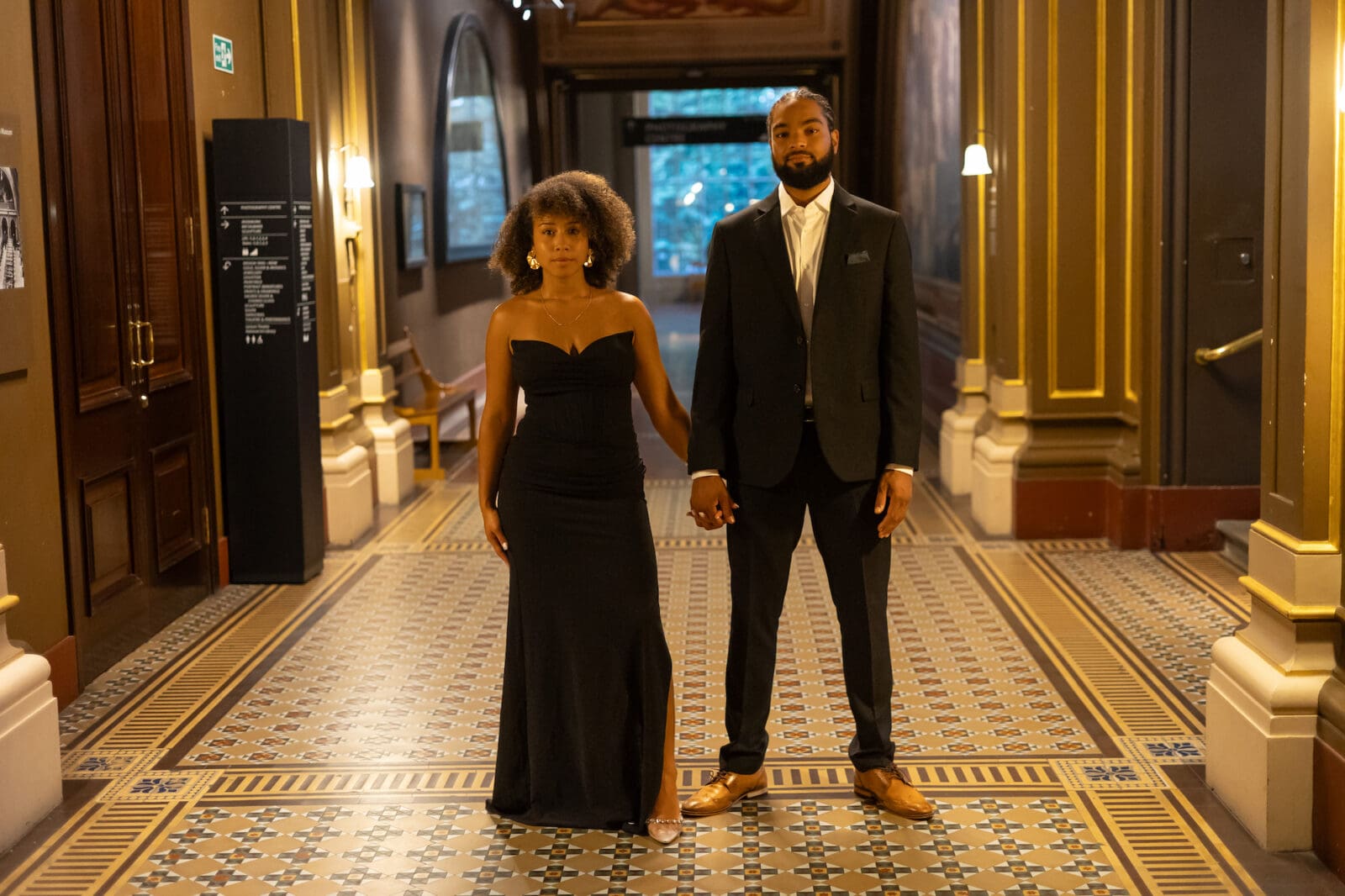 couple holding hands at the V&A museum in london for their engagement shoot