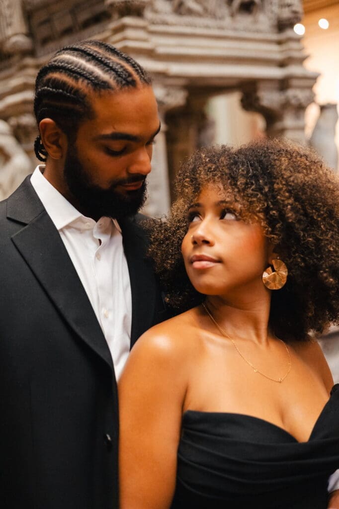 Couple having an intimate moment at the Victoria and Albert Museum for their engagement shoot in London