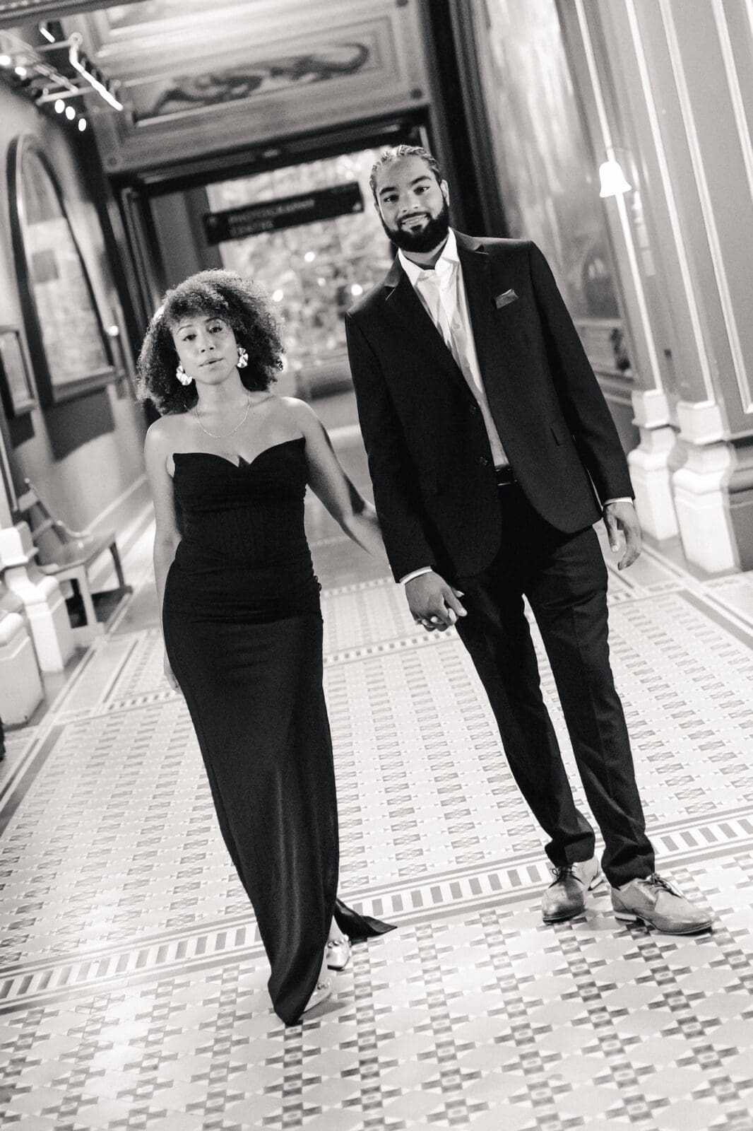 Couple standing in  in gallery corridor at Victoria and Albert Museum during London engagement shoot
