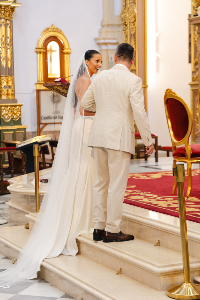 Anna and Michael approach the altar during their wedding ceremony at Iglesia de la Encarnación in Marbella.