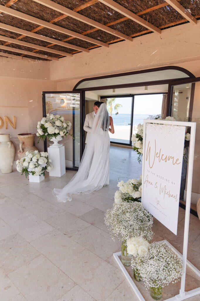 Anna and Michael standing together inside the entrance of their wedding reception venue