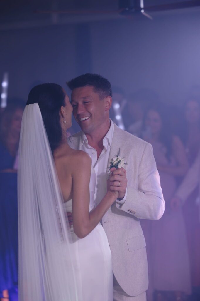 Anna and Michael holding hands together on the wedding dancefloor