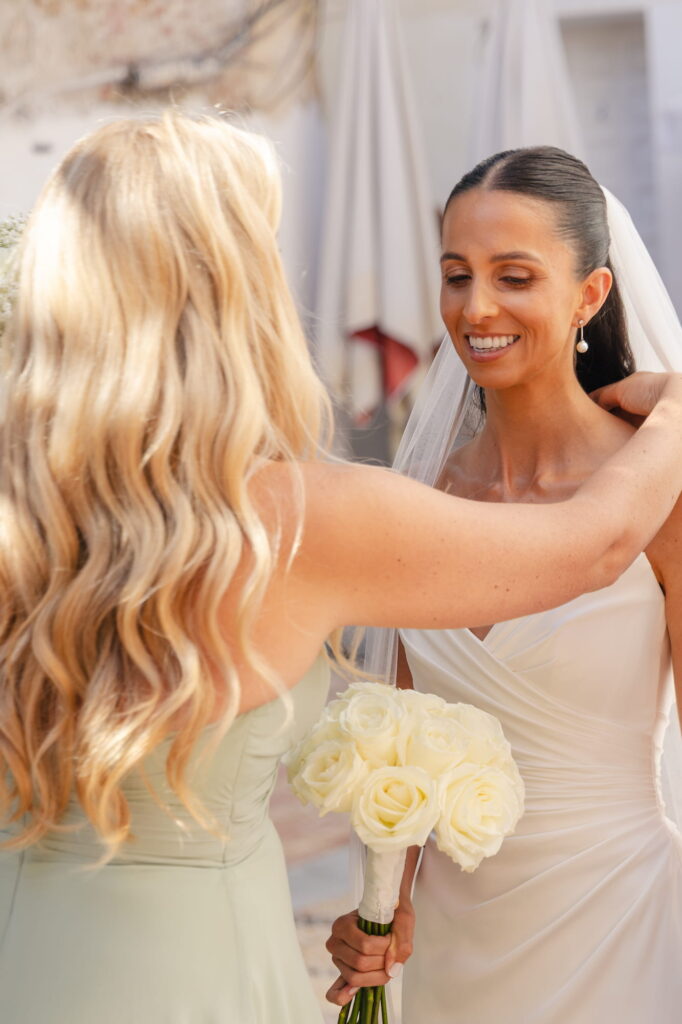 A bridesmaid adjusts Anna's veil as she prepares for the wedding ceremony at Iglesia de la Encarnación in Marbella.