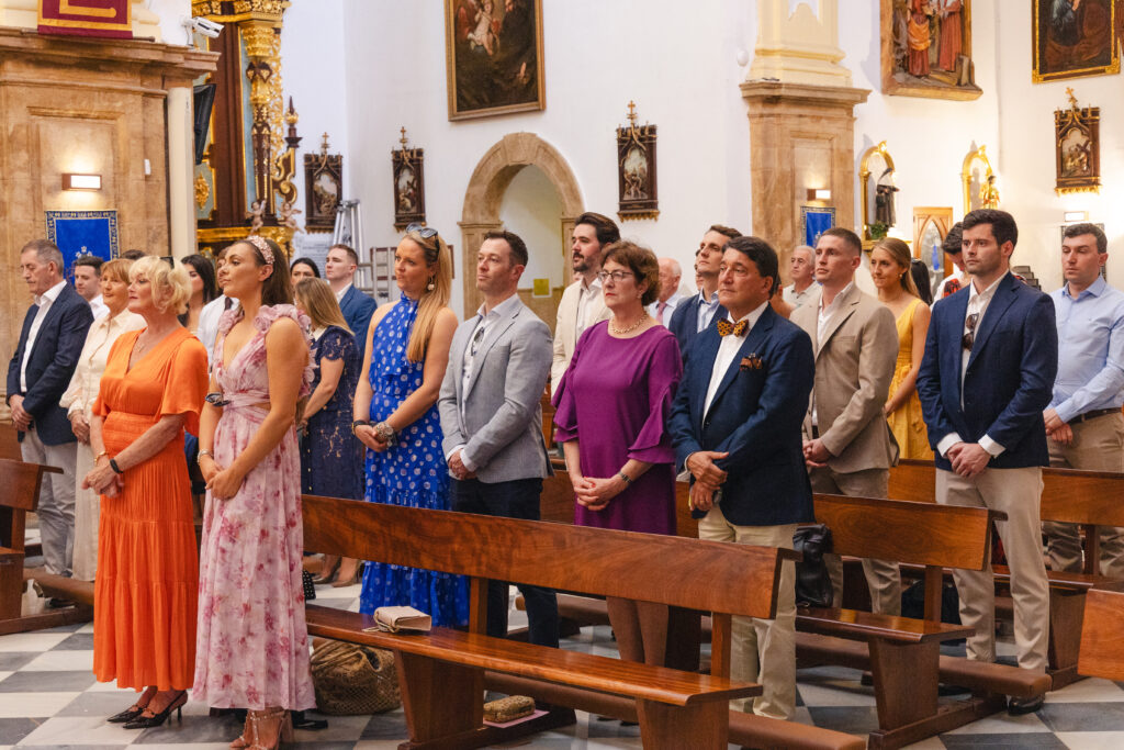 Guests stand inside Iglesia de la Encarnación awaiting Anna's arrival before the wedding ceremony in Marbella.